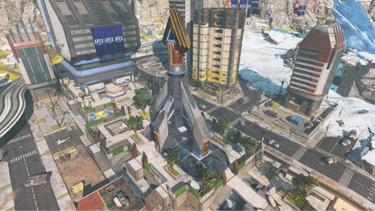 Aerial view of a dense Apex Legends city with tall towers, roads and snowy edges.