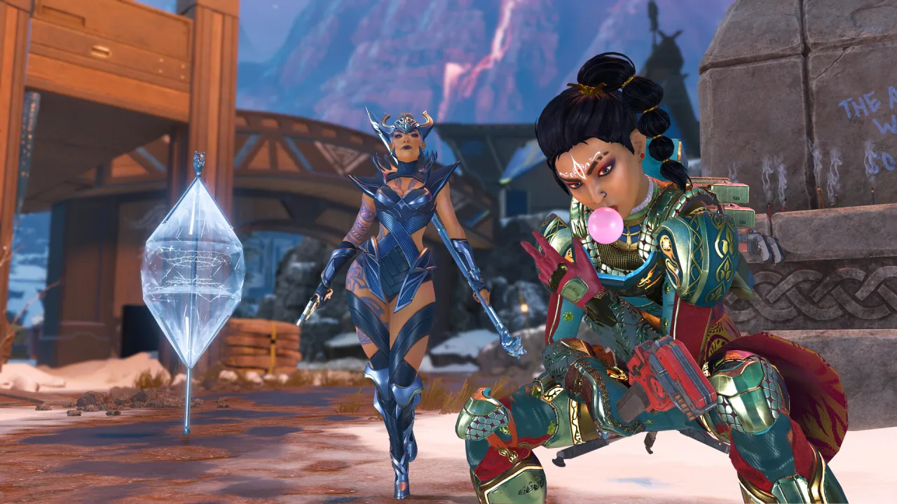 Two Apex Legends characters beside a floating diamond-shaped device in an outdoor courtyard.