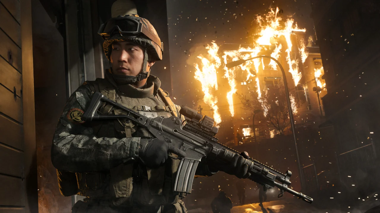 A helmeted Call of Duty soldier holds a rifle beside a burning doorway.
