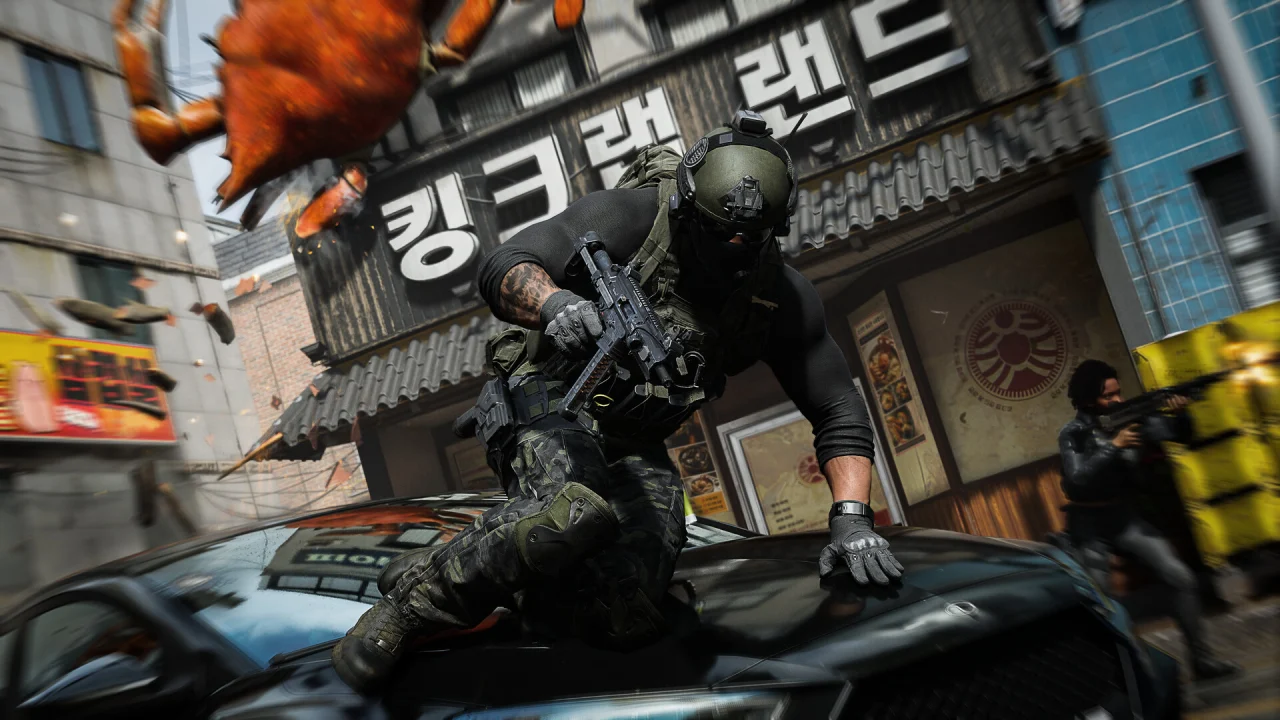An armed Call of Duty operator lands on a car in a city street beside an explosion.