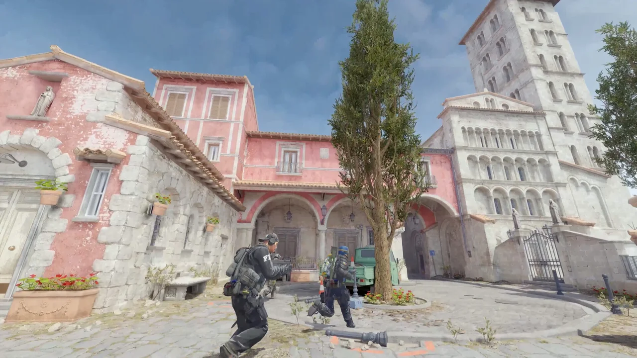 Two Counter-Strike 2 operators move through a sunlit stone plaza.
