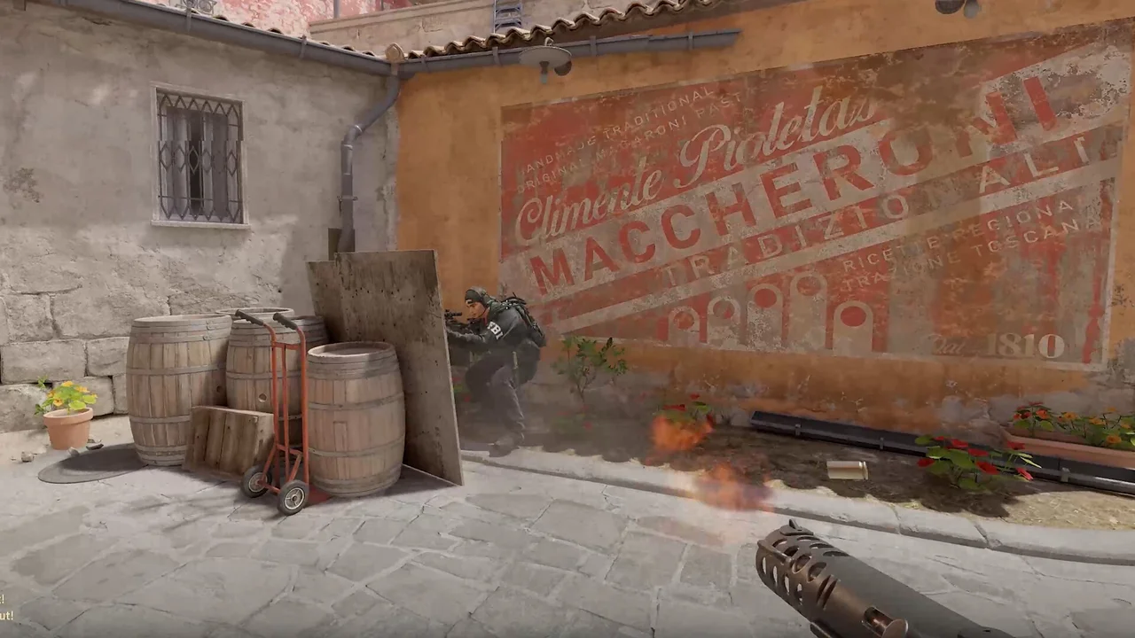 Two Counter-Strike 2 players exchange fire in a narrow market alley.