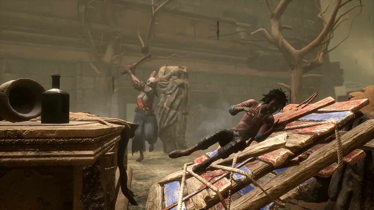 A Survivor crosses a fallen wooden pallet as a Killer approaches inside a ruined room.