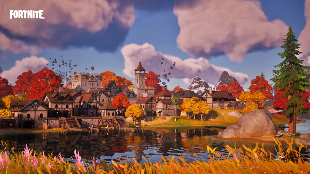 A Fortnite town and autumn trees reflect in a lake beneath large clouds.