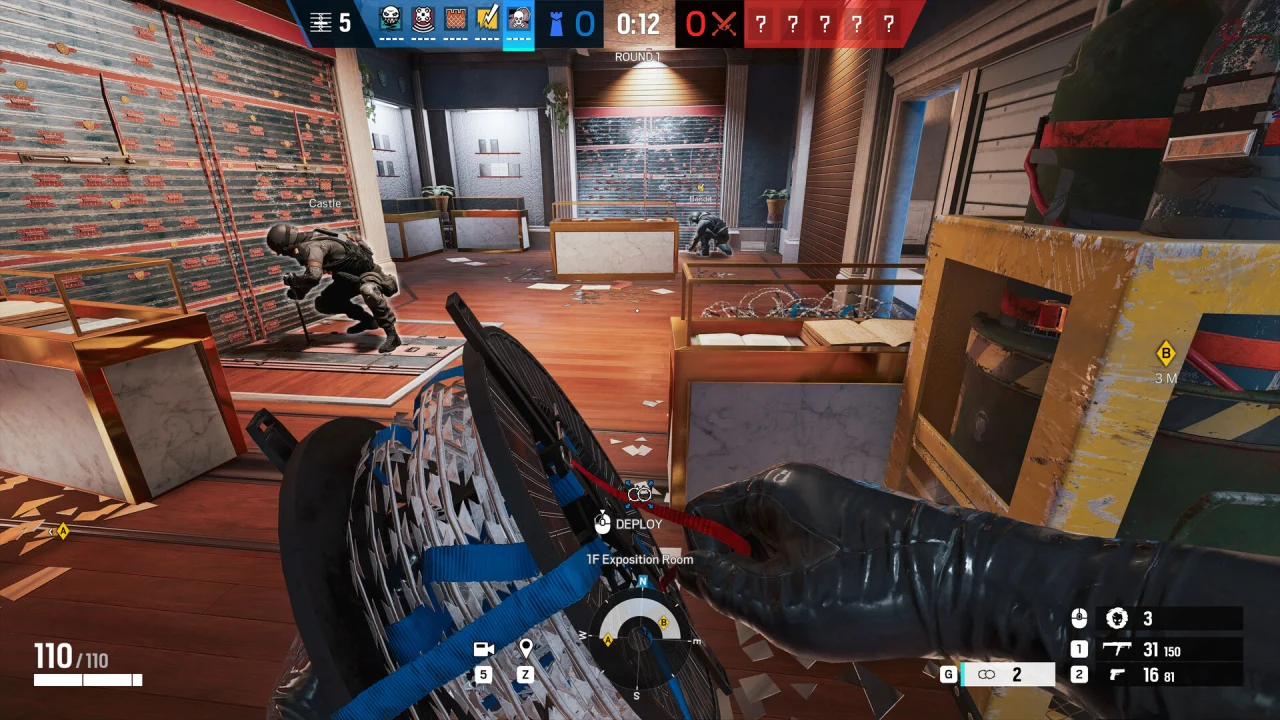 A Siege defender holds coiled barbed wire inside a room with reinforced walls.