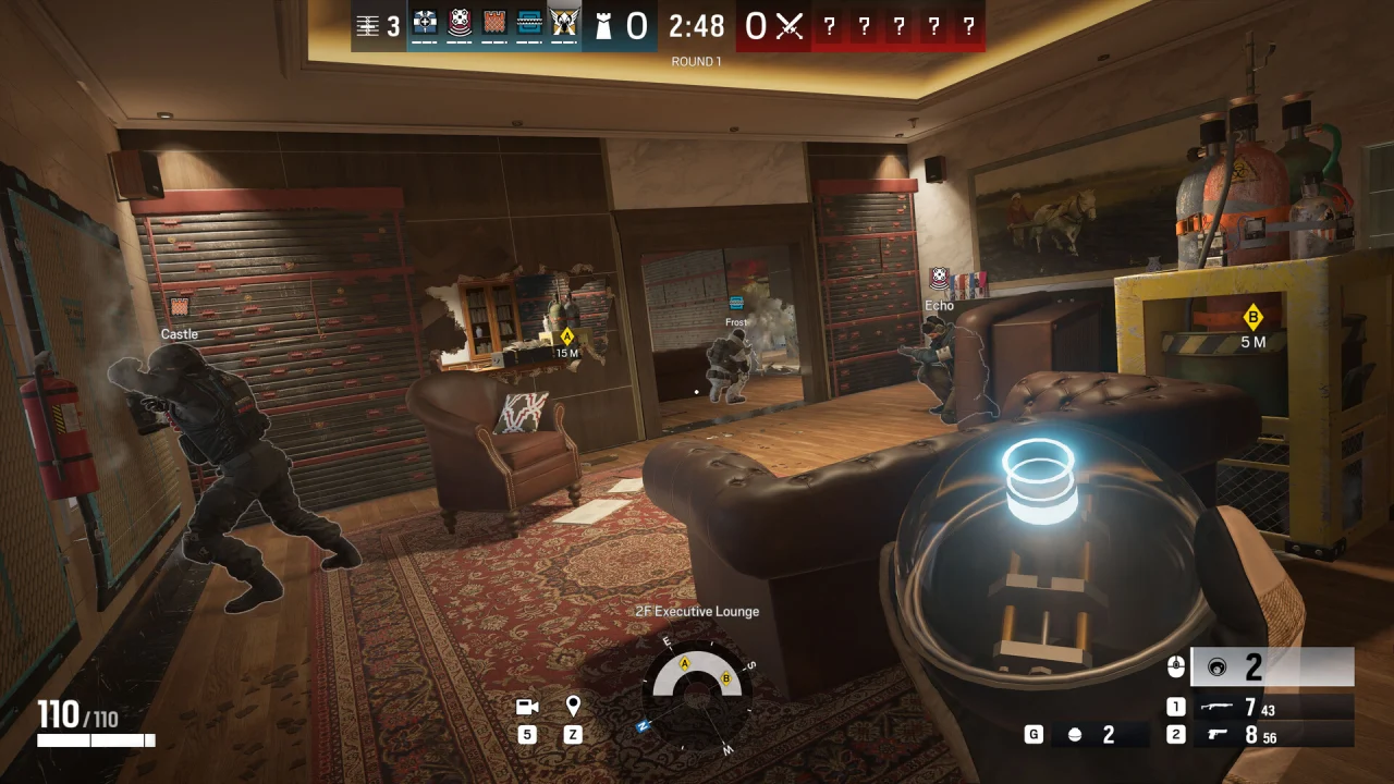 A Siege operator holds a compact device while teammates move through a room with breached walls.