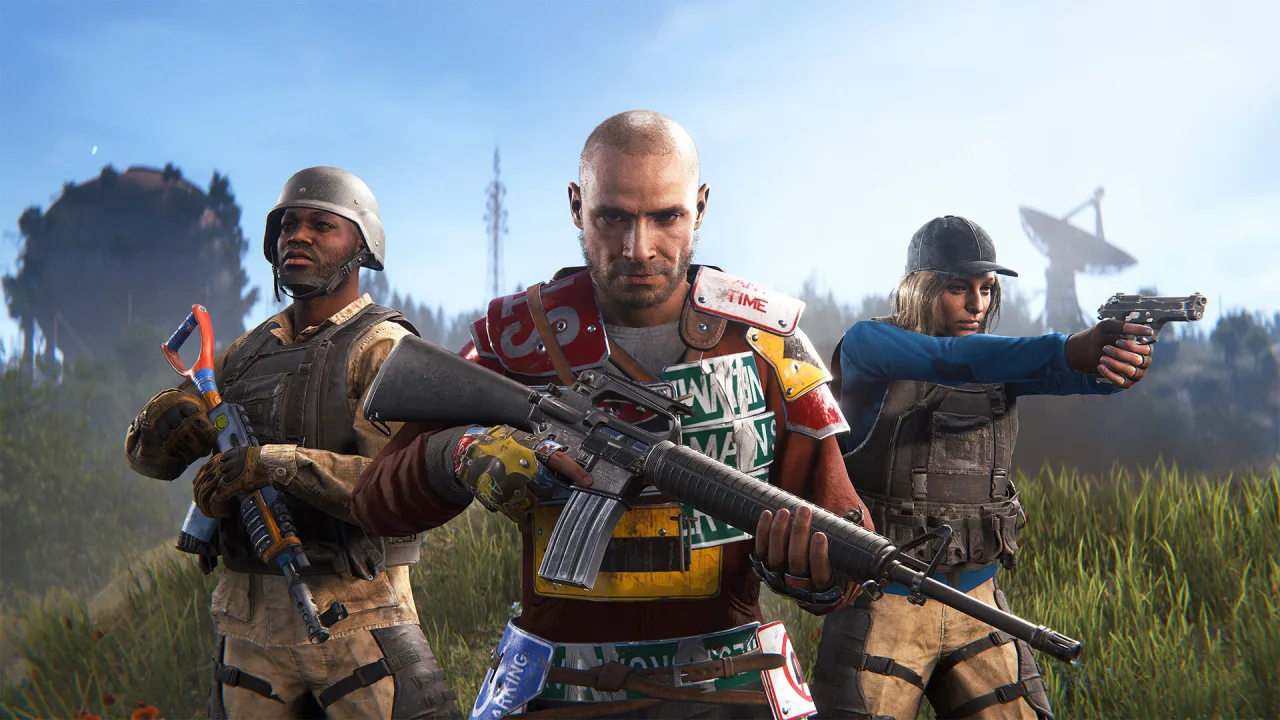Three armed Rust characters stand together in a grassy field with structures behind them.