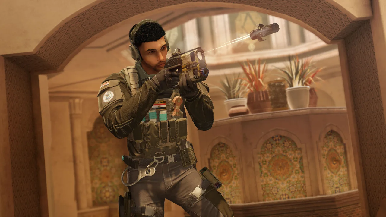 A Rainbow Six Siege operator aims through a stone archway.